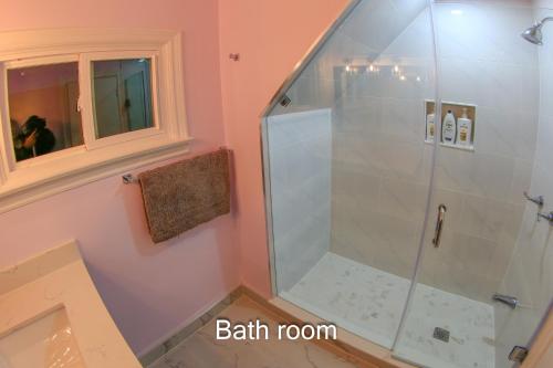 a shower with a glass door in a bathroom at Comfort Home Toronto in Toronto