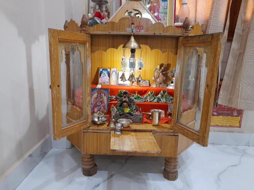 a wooden cabinet filled with toys and other items at Govind Niwas Home Stay in Gwalior