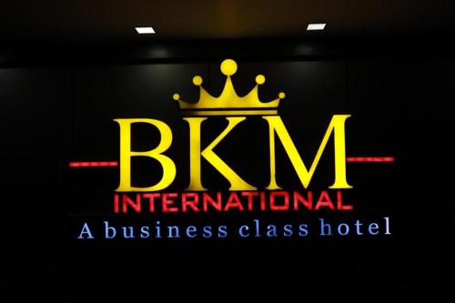 a logo for a business class hotel with a crown at Hotel BKM International in Tellicherry