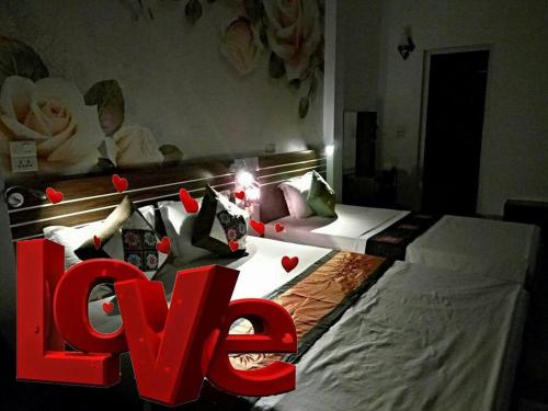 Un ou plusieurs lits dans un hébergement de l'établissement Friendly Home Hotel