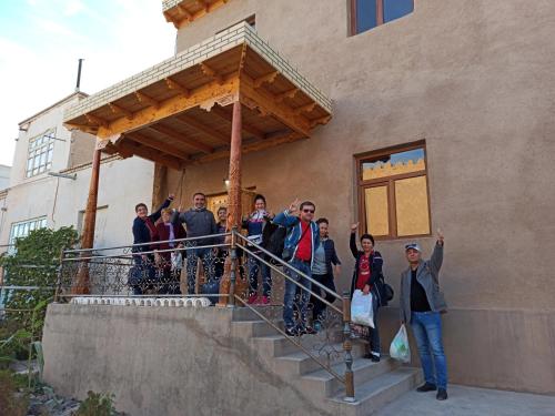 a group of people standing on the stairs of a building at Art House Boutique Hotel in Khiva