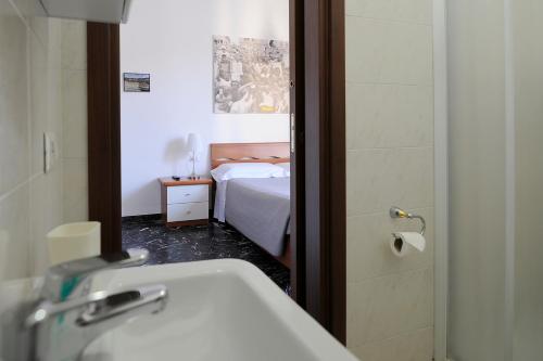 a bathroom with a sink and a bed and a mirror at B&B Calcio Storico in Florence