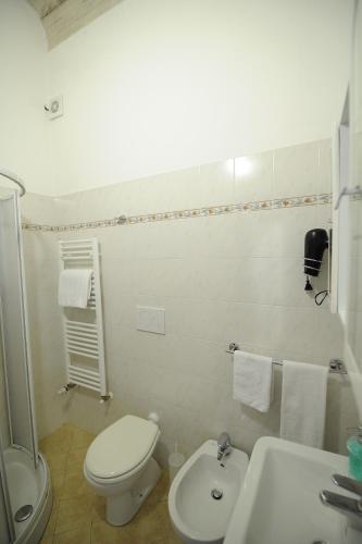 a white bathroom with a toilet and a sink at B&B Calcio Storico in Florence