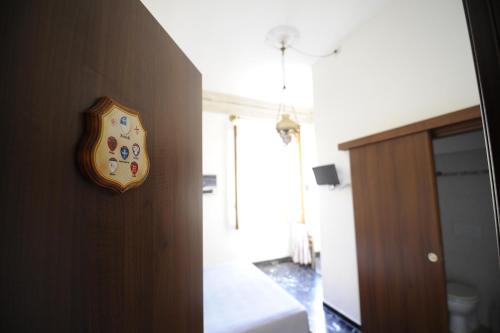 a clock hanging on a wall in a room at B&B Calcio Storico in Florence