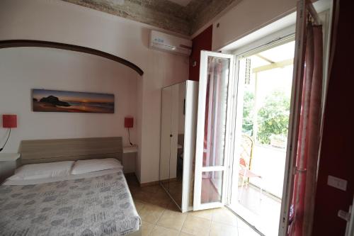 a bedroom with a bed and an open door at B&B Calcio Storico in Florence