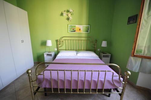 a bedroom with a bed with a purple blanket at B&B Calcio Storico in Florence