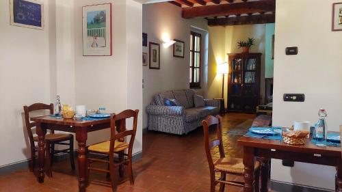 a living room with a table and chairs and a couch at Torrebianca Tuscany in Rignano sullʼArno