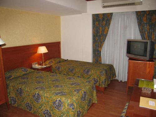 Postel nebo postele na pokoji v ubytování Philippe Luxor Hotel