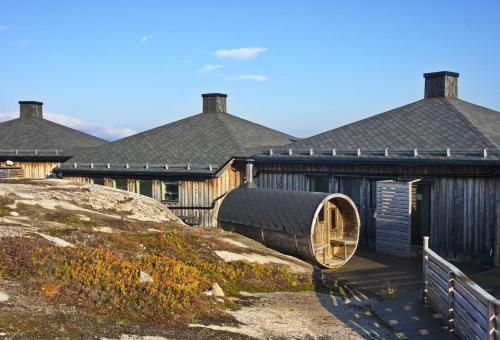 a wooden building with a round window on the side of it at Arctic Lodge in Riksgränsen