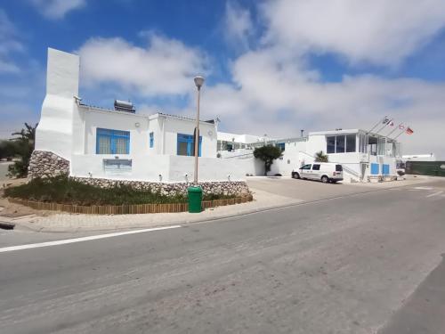 a white building on the side of a street at Paternoster Lodge in Paternoster