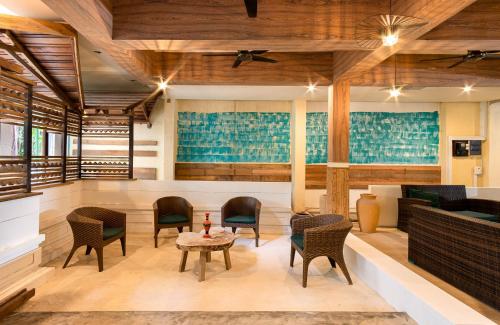 a lobby of a hotel with chairs and a table at West Sands in Ukulhas