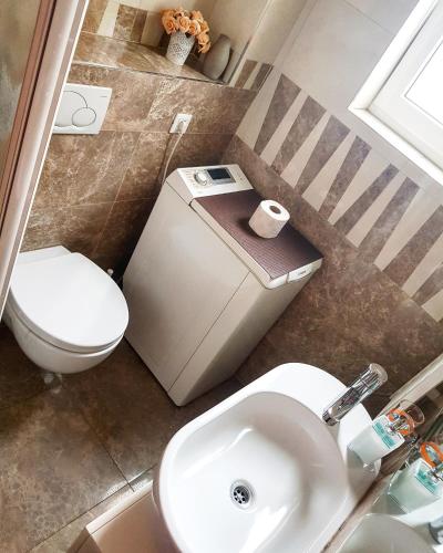 a bathroom with a toilet and a sink at Jolie in Belgrade