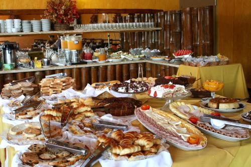a table with many different types of pastries on it at Rio Búzios Beach Hotel in Búzios