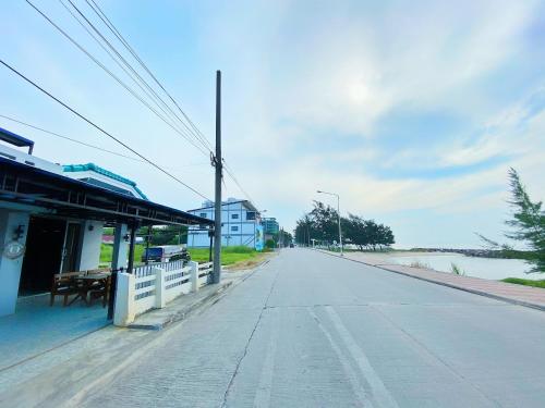 an empty street next to a building next to a river at Sealife Private Beach Villa in Ban Nong Si Tong