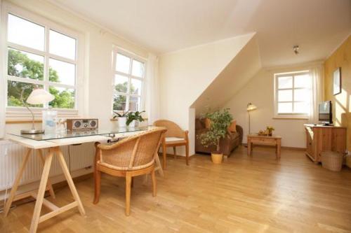 a large living room with a table and chairs at Schimmels Pension in Wustrow