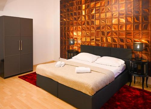 a bedroom with a bed with two towels on it at Elegant Suite Altes AKH in Vienna