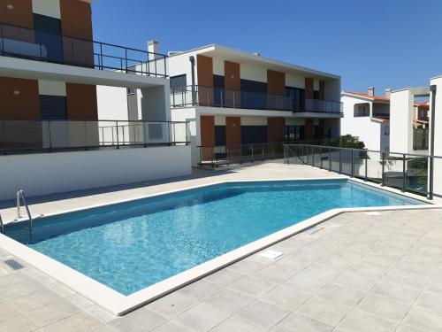 a swimming pool in front of a apartment building at Na Baía in Salir de Porto