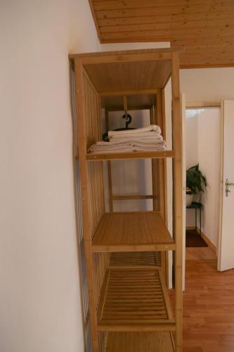 a wooden shelf in a room with towels on it at Cafe-Konditorei-Pension Sander in Niederfell