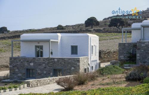 a white house on a hill with a sign at Antiparos Homes in Antiparos Town