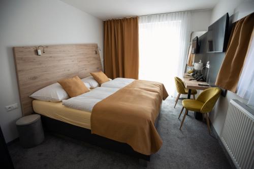 Ένα ή περισσότερα κρεβάτια σε δωμάτιο στο Primma Hotel