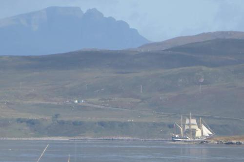 a boat in the water with a hill in the background at Beautiful views from right above the water in Dunan