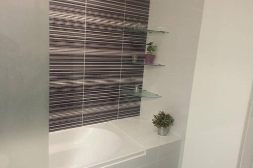 a bathroom with a shower with a wooden blind at T2 Ferragudo Cosy Beach Apartment in Ferragudo