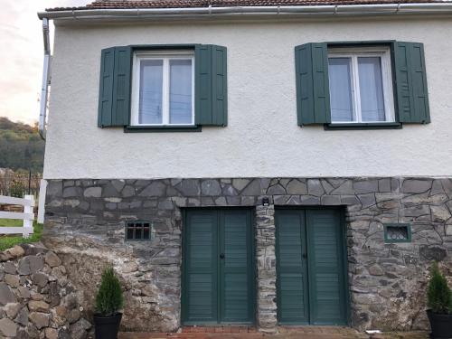 a house with two green doors and two windows at Smaragd in Doba