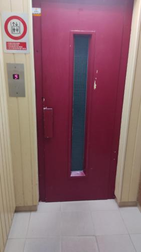 a purple door with a mirror in a hallway at Lorena in Salou