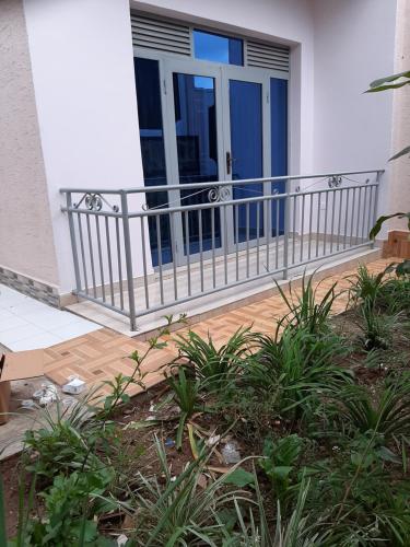 a front porch of a house with a blue door at Puma Aparthotel - Nyarutarama in Kigali