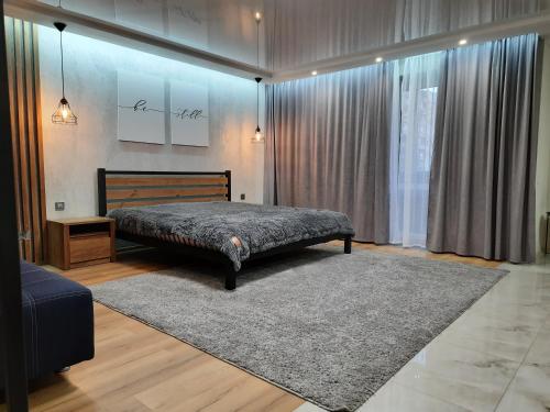 a bedroom with a bed and a rug at ВИТАЛИЯ МАТУСЕВИЧА ДОМ 4 in Kryvyi Rih
