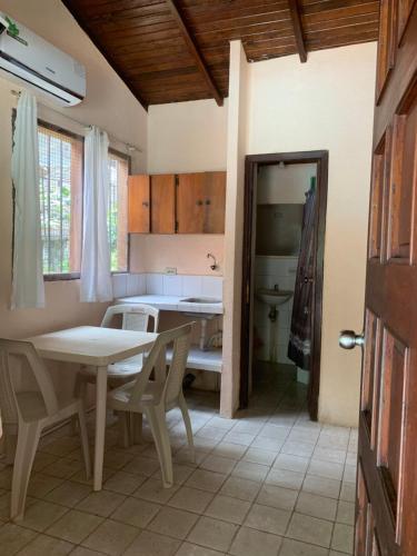 a kitchen with a table and chairs in a room at Cabañas Ecologicas Cayapas in Atacames
