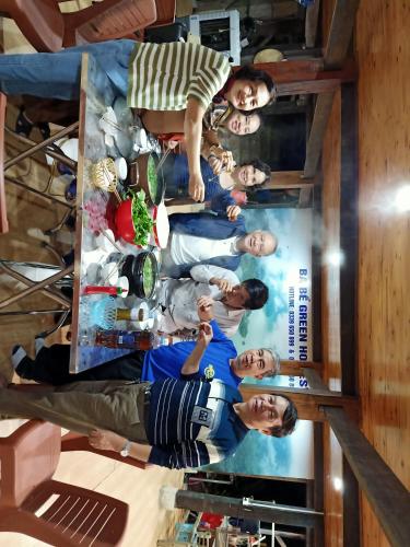 a poster of a group of people in a room at Ba Be Green Homestay in Bak Kan
