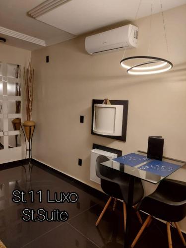 a dining room with a table and a tv at Lual Motel Sorocaba-SP in Sorocaba