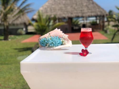 a table with a glass of wine and a piece of cake at Ananta Hotel in Las Casitas