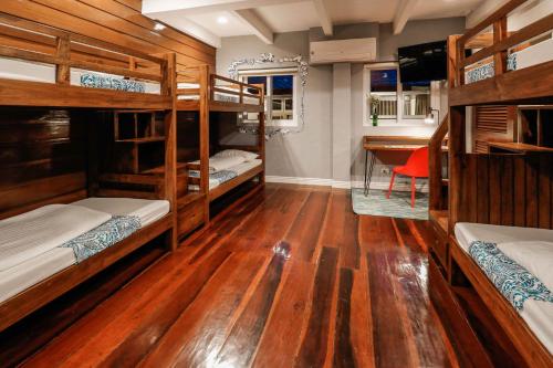 a room with four bunk beds and a desk at Hotel Kimberly Tagaytay in Tagaytay