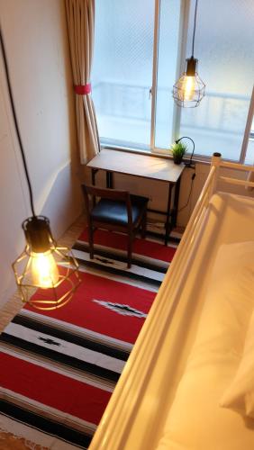 a living room with a lamp and a window at Zabutton Hostel and Coffee in Tokyo