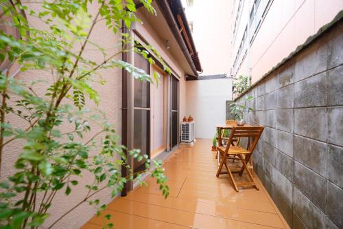 an empty balcony with a table and chairs in a building at 肖舎 Shoya in Nara