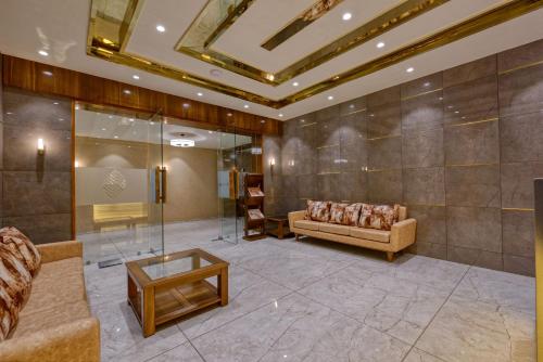a living room with a couch and a table at HOTEL FLOURISH INTERNATIONAL in Ahmedabad