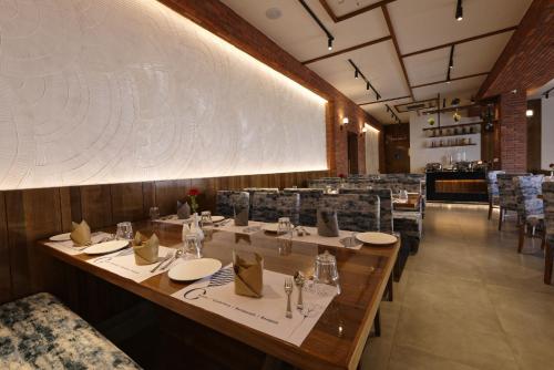 a dining room with a long table and chairs at HOTEL FLOURISH INTERNATIONAL in Ahmedabad