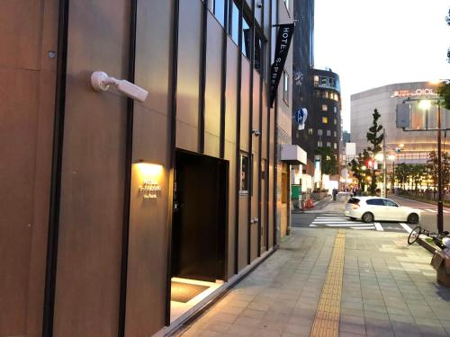 a city street with a building with a window at Hotel S-Presso North in Osaka