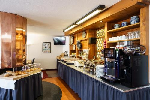 a restaurant with a counter with food on it at Hotel Bernerhof in Interlaken