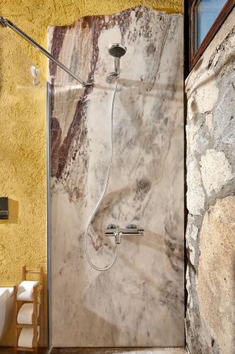 a shower with a shower head in a bathroom at Sunset No: 23 in Ovacık