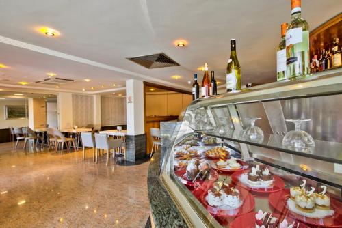 a buffet in a hotel with food and wine bottles at Hotel Santana in St Paul's Bay
