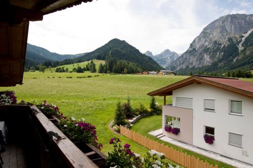 a view from the balcony of a house in the mountains at Berghotel Lämmerhof in Sankt Martin am Tennengebirge