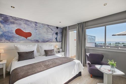 a hotel room with a bed and a large window at Hotel Joan Miró Museum in Palma de Mallorca