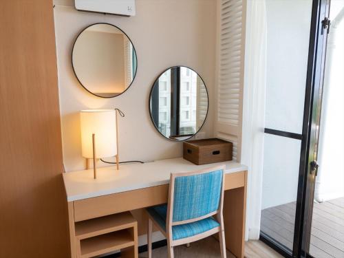 a dressing room with a desk and two mirrors at Palace In Moon Beach in Onna