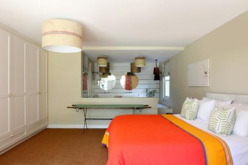a bedroom with a bed and a desk at The Library in Franschhoek