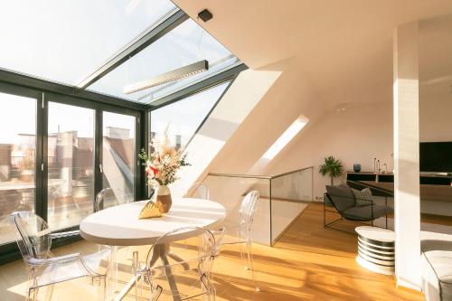 a living room with a white table and chairs at Mint@Naschmarkt Premium Apartments in Vienna