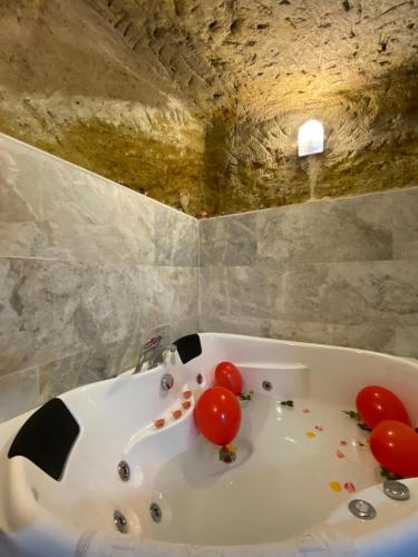 a bathroom with a white tub with debris on it at Ürgüp Inn Cave Hotel in Urgup