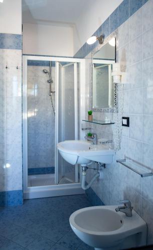 a white bathroom with a sink and a shower at Hotel Residence Riviera Calabra in Zambrone